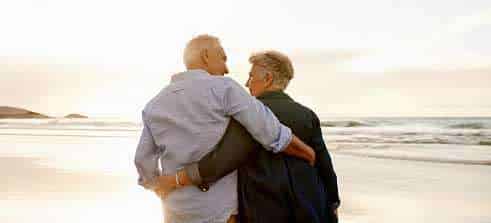couple on the beach enjoying retirement