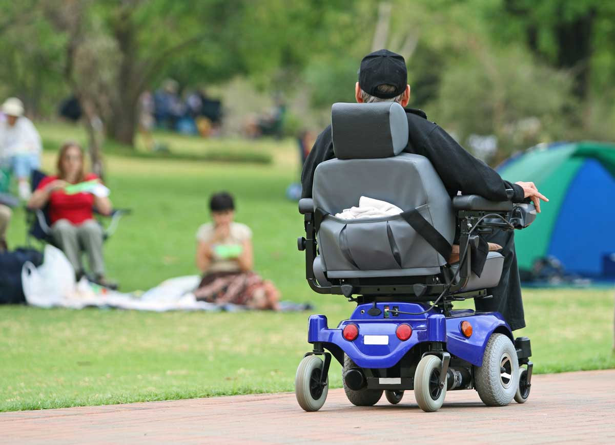 man on electric wheelchair in park