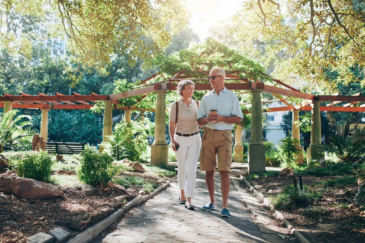 happy-senior-couple-walking-together-in-a-city