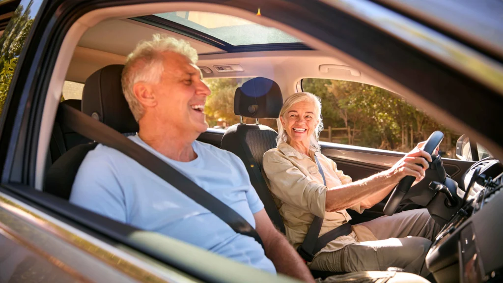 senior-couple-enjoying-summer-day-trip-out-driving