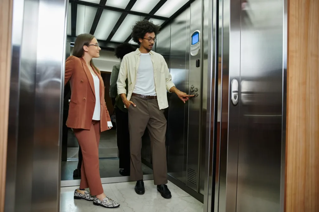 office-colleagues-chatting-in-elevator