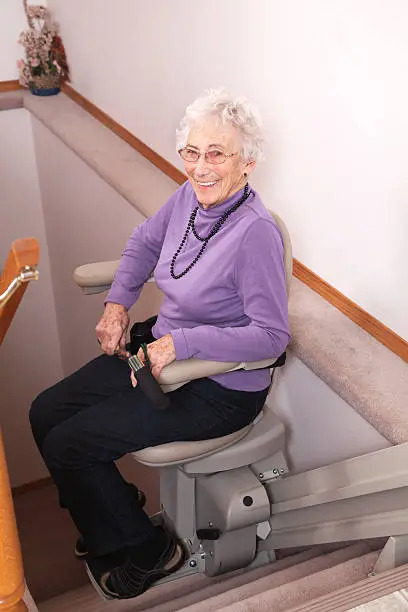 woman-sitting-on-stairlift