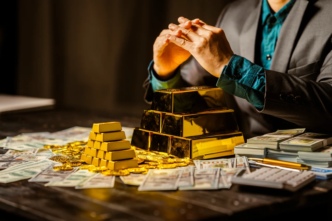 a-businessman-sits-at-his-desk-in-a-nighttime-with-gold