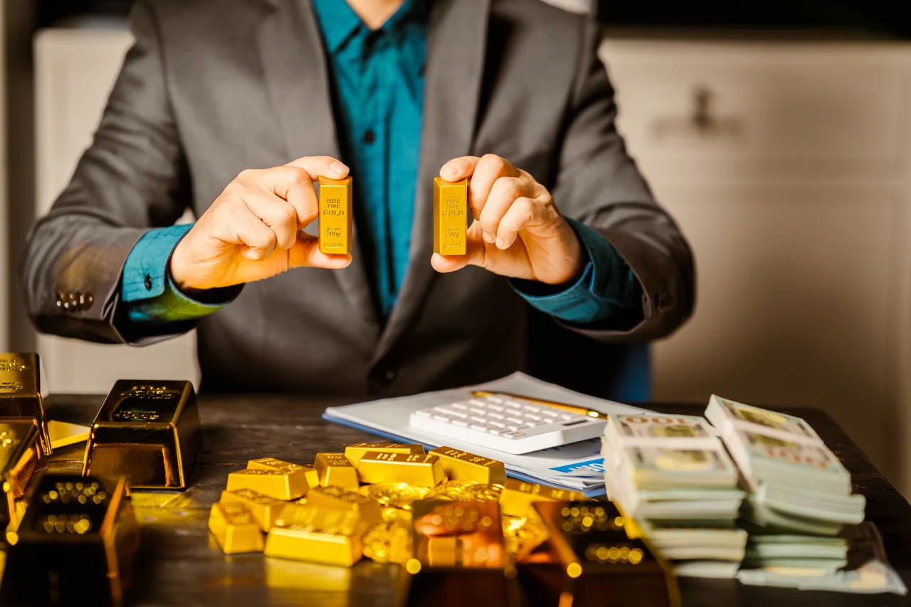 a-businessman-sits-at-his-desk-with-gold